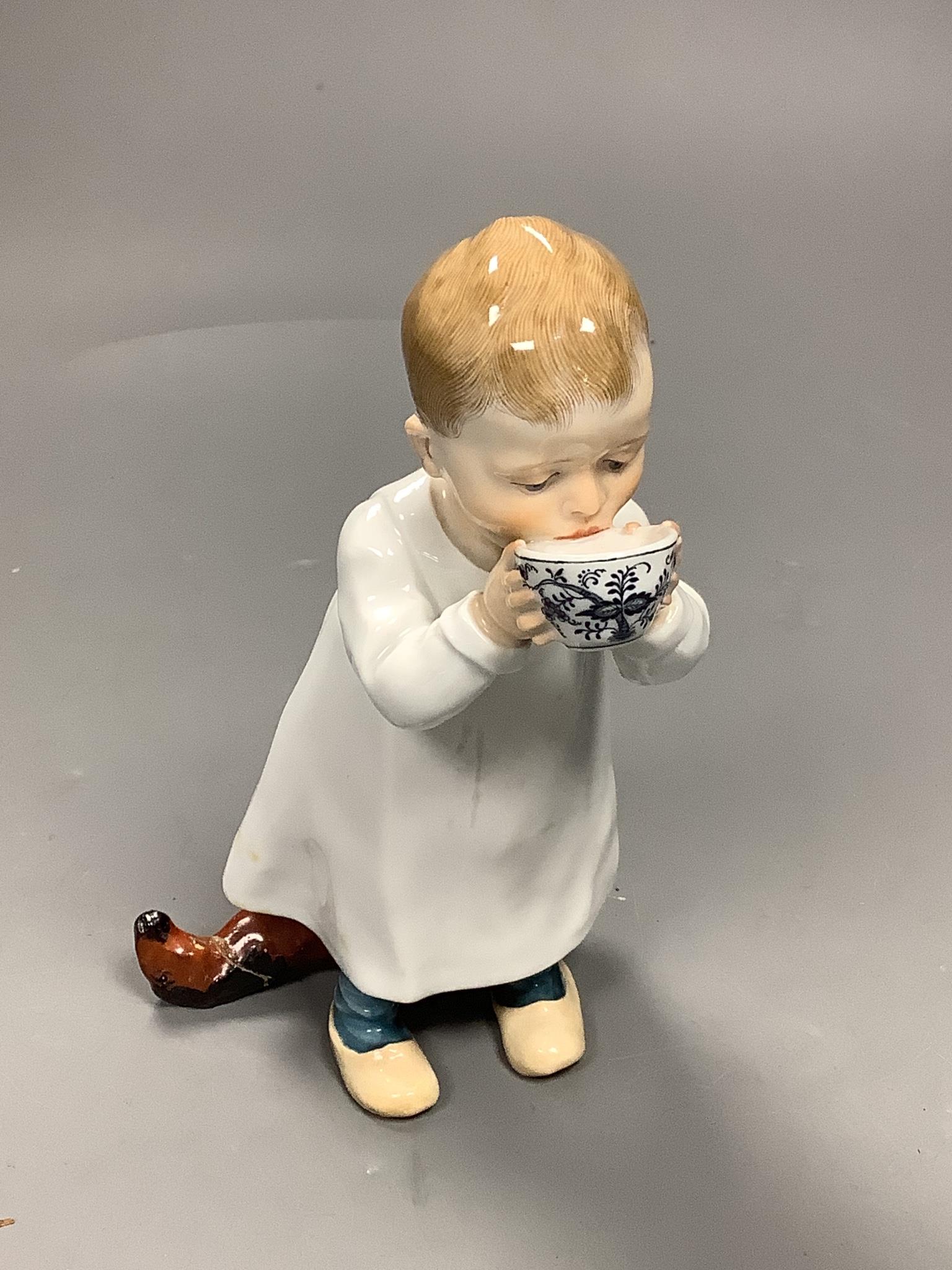 A Meissen figure of a child drinking from a bowl, modelled by Konrad Hentschel, c.1905-1924, 16cm high, faults